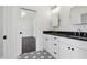 Modern bathroom featuring a double vanity with black countertops and a striking patterned floor at 262 Green Hill Ne Rd, Sandy Springs, GA 30342