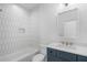 Modern bathroom featuring stylish wall tiles and a sleek vanity with blue cabinets at 262 Green Hill Ne Rd, Sandy Springs, GA 30342