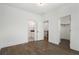 Bedroom with hardwood floors, two doors, and an ensuite bathroom and closet at 262 Green Hill Ne Rd, Sandy Springs, GA 30342