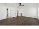 A bright bedroom featuring hardwood floors, ceiling fan, and white trim throughout the space at 262 Green Hill Ne Rd, Sandy Springs, GA 30342