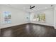 Bright bedroom featuring three large windows offering an abundance of natural light and dark hardwood floors at 262 Green Hill Ne Rd, Sandy Springs, GA 30342
