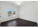 Bedroom featuring a window with natural light and sleek, dark hardwood floors at 262 Green Hill Ne Rd, Sandy Springs, GA 30342