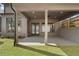 The covered patio has a concrete floor, ceiling fan, recessed lighting and offers shade from the sun at 262 Green Hill Ne Rd, Sandy Springs, GA 30342