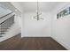 Dining space with modern lighting, hardwood floors, stairs, and a window at 262 Green Hill Ne Rd, Sandy Springs, GA 30342