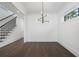 Bright dining area with dark floors, modern lighting, and nearby stairway at 262 Green Hill Ne Rd, Sandy Springs, GA 30342