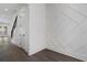Bright entryway with hardwood floors, decorative wall paneling, and stairway access at 262 Green Hill Ne Rd, Sandy Springs, GA 30342