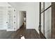 Bright entryway with dark wood floors, white trim, and decorative wall paneling at 262 Green Hill Ne Rd, Sandy Springs, GA 30342