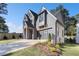 Beautiful gray home showcasing a driveway, green lawn, with professional landscaping at 262 Green Hill Ne Rd, Sandy Springs, GA 30342