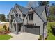 Beautiful two-story home boasts gray brick, gray roof, and an attached two car garage with manicured front lawn at 262 Green Hill Ne Rd, Sandy Springs, GA 30342