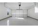 Spacious garage with epoxy floors, and functional garage door with opener at 262 Green Hill Ne Rd, Sandy Springs, GA 30342
