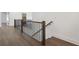 Second-floor hallway with wood floors and wrought iron railing overlooking staircase at 262 Green Hill Ne Rd, Sandy Springs, GA 30342