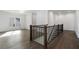 Open hallway with hardwood floors and a staircase with black iron railings at 262 Green Hill Ne Rd, Sandy Springs, GA 30342