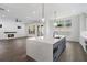 Open-concept kitchen with an island, fireplace in the background, and hardwood floors at 262 Green Hill Ne Rd, Sandy Springs, GA 30342