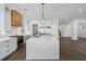 Open concept kitchen with a large island, white countertops, stainless steel appliances, and modern lighting at 262 Green Hill Ne Rd, Sandy Springs, GA 30342