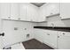 Well-equipped laundry room with white cabinets, a sink, and sleek countertops at 262 Green Hill Ne Rd, Sandy Springs, GA 30342