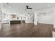 Spacious living room with open floor plan to kitchen, featuring fireplace and hardwood floors at 262 Green Hill Ne Rd, Sandy Springs, GA 30342