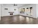 Bright living room with fireplace, hardwood floors, and sliding glass doors to patio at 262 Green Hill Ne Rd, Sandy Springs, GA 30342
