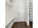 Mudroom with storage, bench, shelving and coat hooks adjacent to door at 262 Green Hill Ne Rd, Sandy Springs, GA 30342