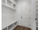 Mudroom with storage, bench, shelving and coat hooks adjacent to door at 262 Green Hill Ne Rd, Sandy Springs, GA 30342
