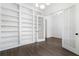 Home office with dark floors, recessed lighting, large built-in shelving, and glass paneled doors at 262 Green Hill Ne Rd, Sandy Springs, GA 30342