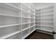 Organized pantry with ample white shelving and hardwood floor at 262 Green Hill Ne Rd, Sandy Springs, GA 30342