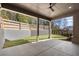 Covered outdoor patio with a ceiling fan, concrete floor, and backyard view with landscaping at 262 Green Hill Ne Rd, Sandy Springs, GA 30342