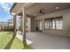 Inviting covered patio with concrete flooring, ceiling fan and view of the landscaped backyard at 262 Green Hill Ne Rd, Sandy Springs, GA 30342