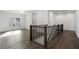 Second floor loft space with wood floors and wrought iron railing at 262 Green Hill Ne Rd, Sandy Springs, GA 30342