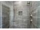 Modern tiled shower with rainfall shower head and a built-in niche for toiletries at 262 Green Hill Ne Rd, Sandy Springs, GA 30342