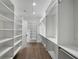 Well-organized walk-in closet with custom shelving, ample storage space and hardwood floors at 262 Green Hill Ne Rd, Sandy Springs, GA 30342