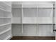 Organized walk-in closet featuring adjustable shelving and hanging rods at 262 Green Hill Ne Rd, Sandy Springs, GA 30342