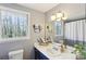 Bright bathroom featuring modern fixtures, natural light, and a window view of the lush outdoors at 3870 Wyntuck Nw Ct, Kennesaw, GA 30152