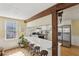 Modern kitchen with a long breakfast bar, wooden beams, and stainless steel appliances at 3870 Wyntuck Nw Ct, Kennesaw, GA 30152