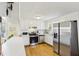 Bright kitchen featuring stainless steel appliances, white cabinetry, and hardwood floors for a modern, clean aesthetic at 3870 Wyntuck Nw Ct, Kennesaw, GA 30152