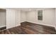 Finished basement with wood floors, white trim, and a window at 6219 Heardsville Rd, Cumming, GA 30028