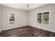 Bedroom featuring ceiling fan, neutral walls, wood-look floors, and many windows for natural light at 6219 Heardsville Rd, Cumming, GA 30028