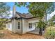 Beautiful, classic American farmhouse features a brick chimney, covered porch, and fresh white paint at 6219 Heardsville Rd, Cumming, GA 30028