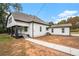 This home features a freshly painted white exterior, black trim, and updated landscaping at 6219 Heardsville Rd, Cumming, GA 30028