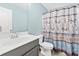 Bathroom with modern vanity, neutral paint, and patterned shower curtain for added style at 1262 Park Pass Row, Suwanee, GA 30024