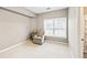Cozy bedroom features a comfortable armchair and a bright window for natural light at 1262 Park Pass Row, Suwanee, GA 30024