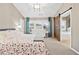 Vaulted ceiling in a cozy bedroom with large windows and a sliding barn door at 1262 Park Pass Row, Suwanee, GA 30024