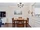 Inviting dining area with a wooden table, chairs, and modern lighting fixture at 1262 Park Pass Row, Suwanee, GA 30024