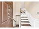 Inviting entryway featuring wood stairs, trim, and a view into the adjacent living space at 1262 Park Pass Row, Suwanee, GA 30024