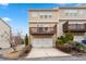 Exterior view of the townhome features a private deck above the attached garage and landscaping at 1262 Park Pass Row, Suwanee, GA 30024