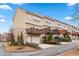 Townhome showcases a private deck, an attached garage, and well-maintained landscaping at 1262 Park Pass Row, Suwanee, GA 30024