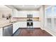 Modern kitchen with white cabinets, stainless steel appliances, granite countertops, and hardwood floors at 1262 Park Pass Row, Suwanee, GA 30024