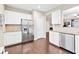 Bright kitchen with stainless appliances, sleek countertops, and hardwood floors offer both style and functionality at 1262 Park Pass Row, Suwanee, GA 30024