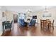 Bright living room featuring hardwood floors, fireplace, comfortable seating, and an adjacent dining area at 1262 Park Pass Row, Suwanee, GA 30024