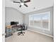 Home office with large window and neutral walls; ceiling fan and overhead lighting at 1262 Park Pass Row, Suwanee, GA 30024