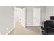 Home office, carpeted with neutral gray walls and white trim at 1262 Park Pass Row, Suwanee, GA 30024